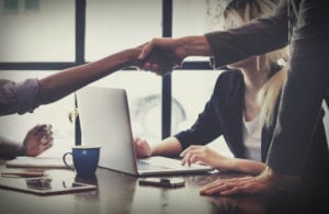 shaking hands in business meeting