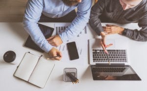 two businessmen on laptop learning