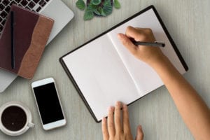 woman writing in notebook