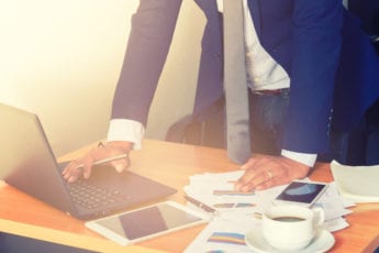 Business man looking at data on laptop