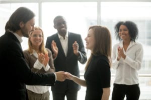 group of employees shaking hands